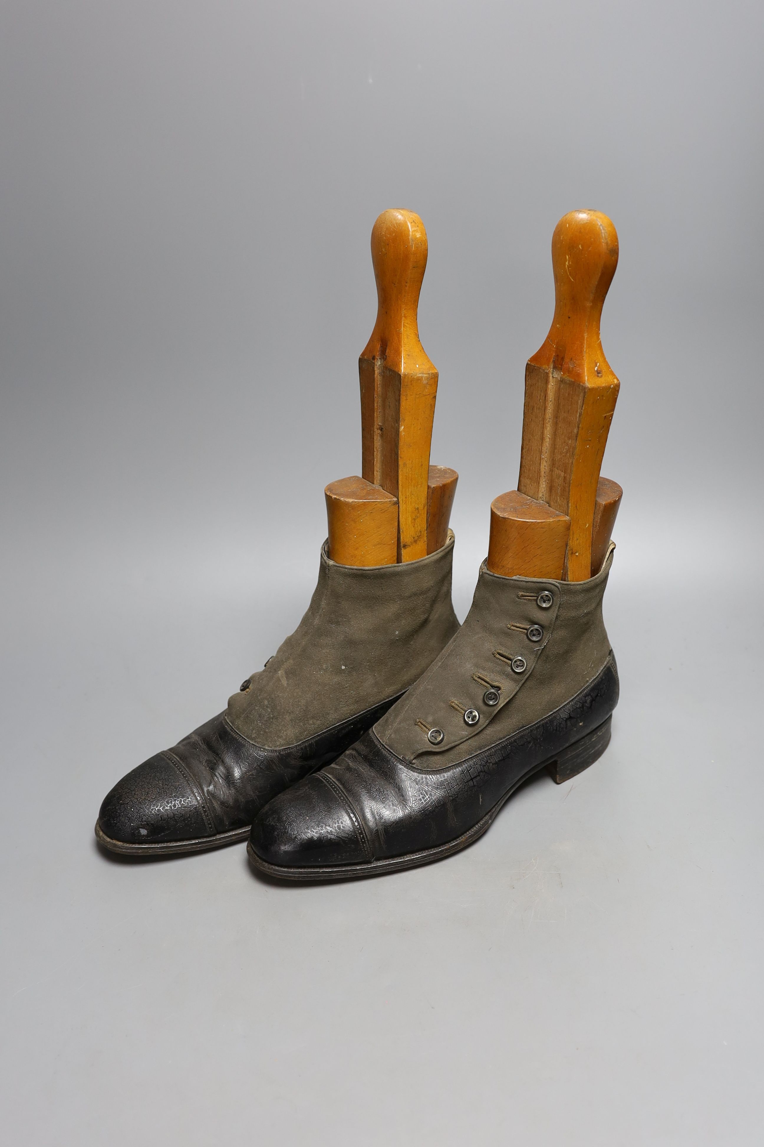 A pair of 19th century buttoned boots, a pair of spats, a red silk jockey's cap, a pair of spurs and another pair sleeves and bodice.
